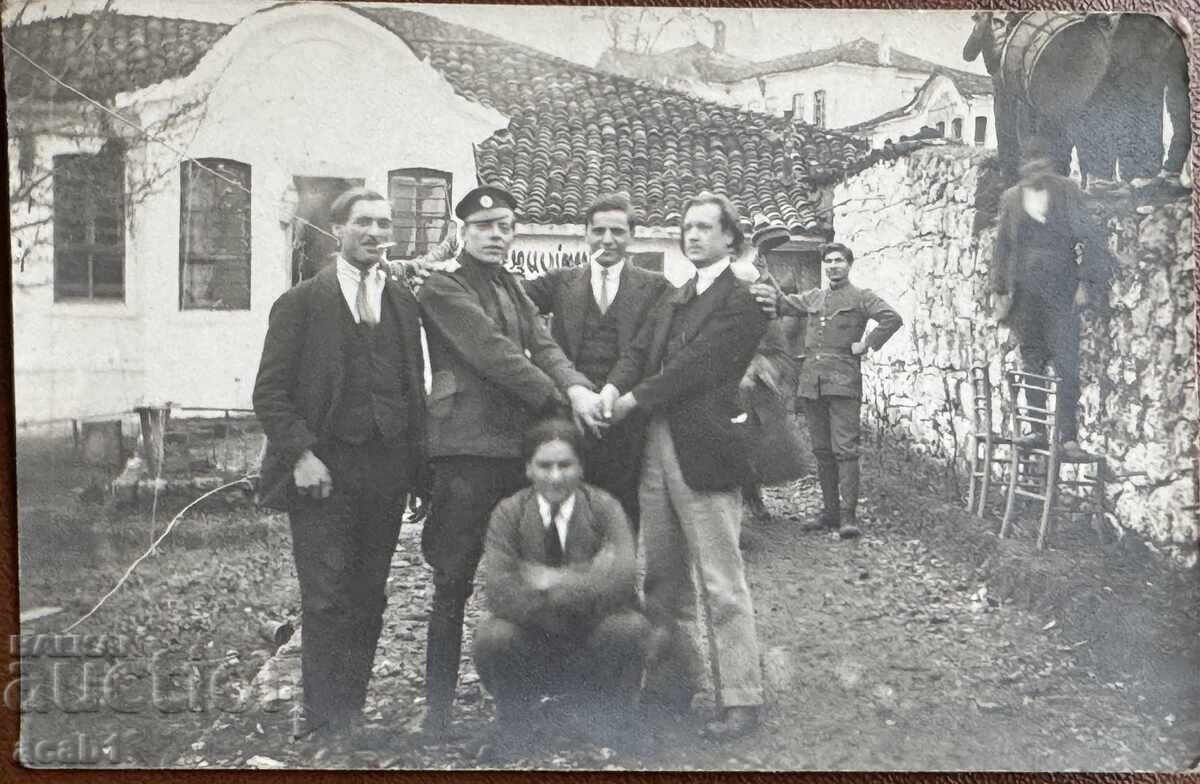 Photograph of musicians entering the courtyard through the wall