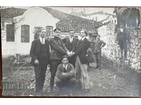 Photograph of musicians entering the courtyard through the wall