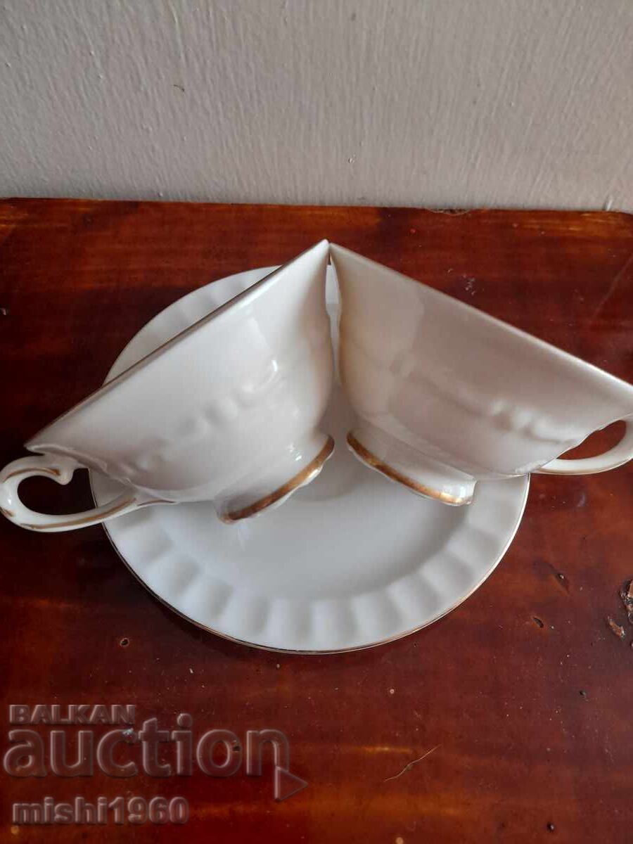 Set of two cups and a saucer