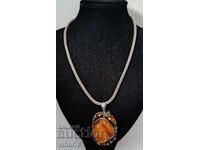 Large silver pendant and brooch with several types of amber