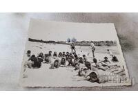 Photo Boys and girls lying on the beach