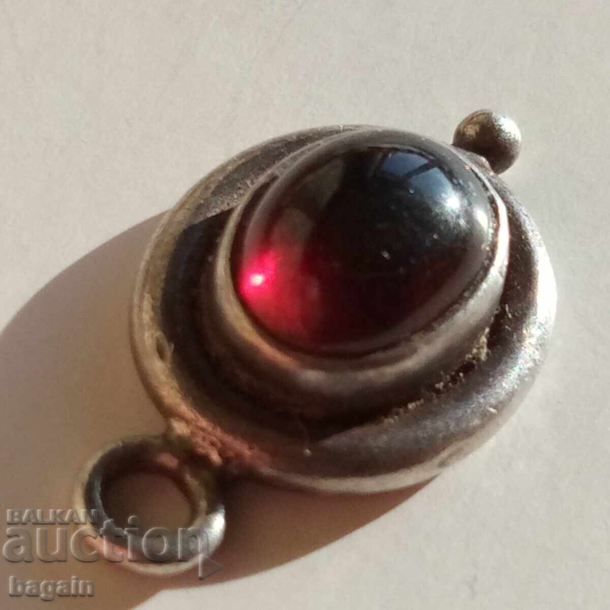 Silver pendant with garnet.