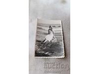 Photo Varna Woman sitting on a stone on the seashore 1935