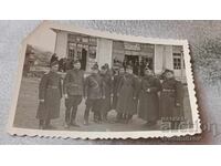 Photo Officers and soldiers in front of the Liquor Store