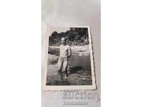 Photo A man in a swimsuit by a river