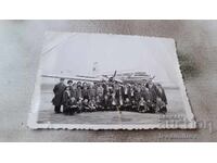 Photo Men women and children on the runway in front of a plane at BGA Balkan