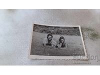 Photo Two young girls lying on the grass