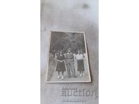 Photo: Young man and two girls in the park