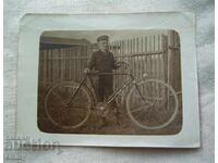 Old photo of a boy with a bicycle, bike