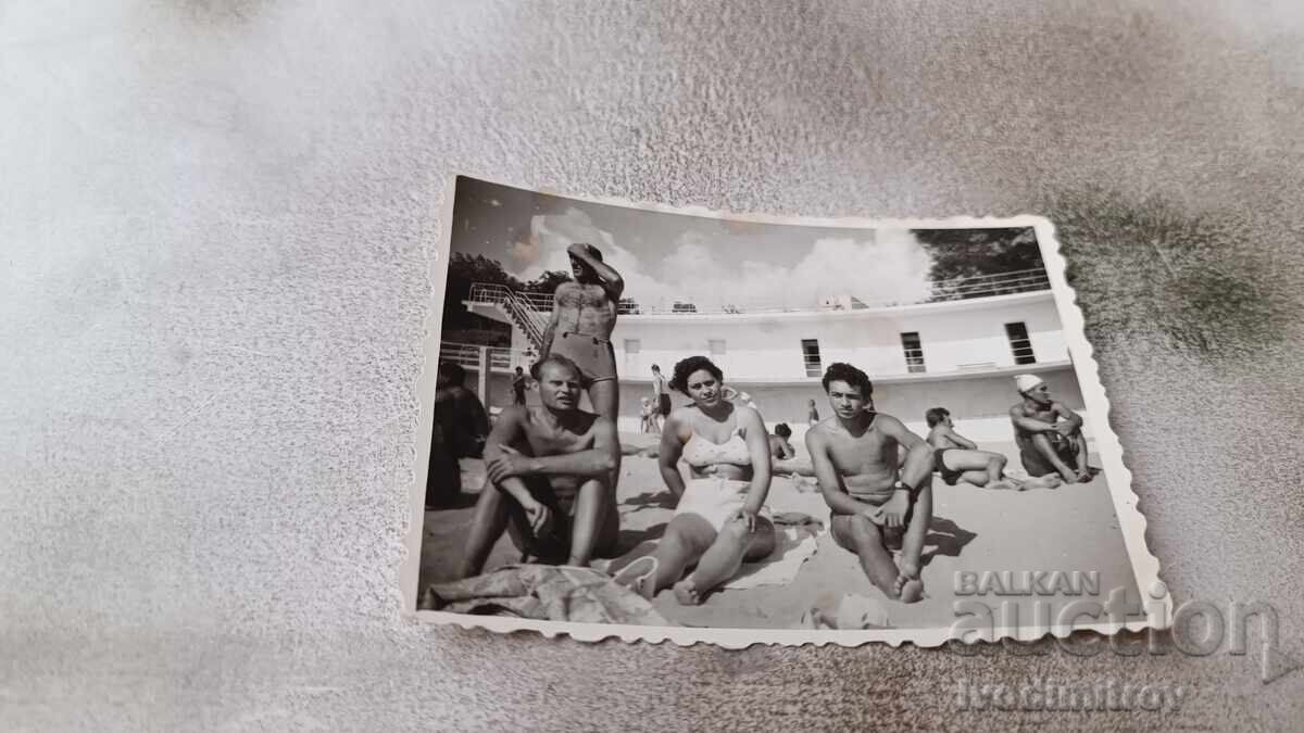 Photo Three men and a woman on the beach Photo Three men and a woman on the beach