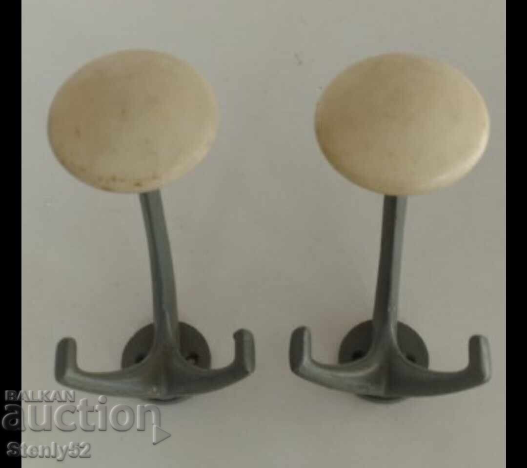 2 old aluminum hangers with balls. 2 old aluminum hangers with balls.