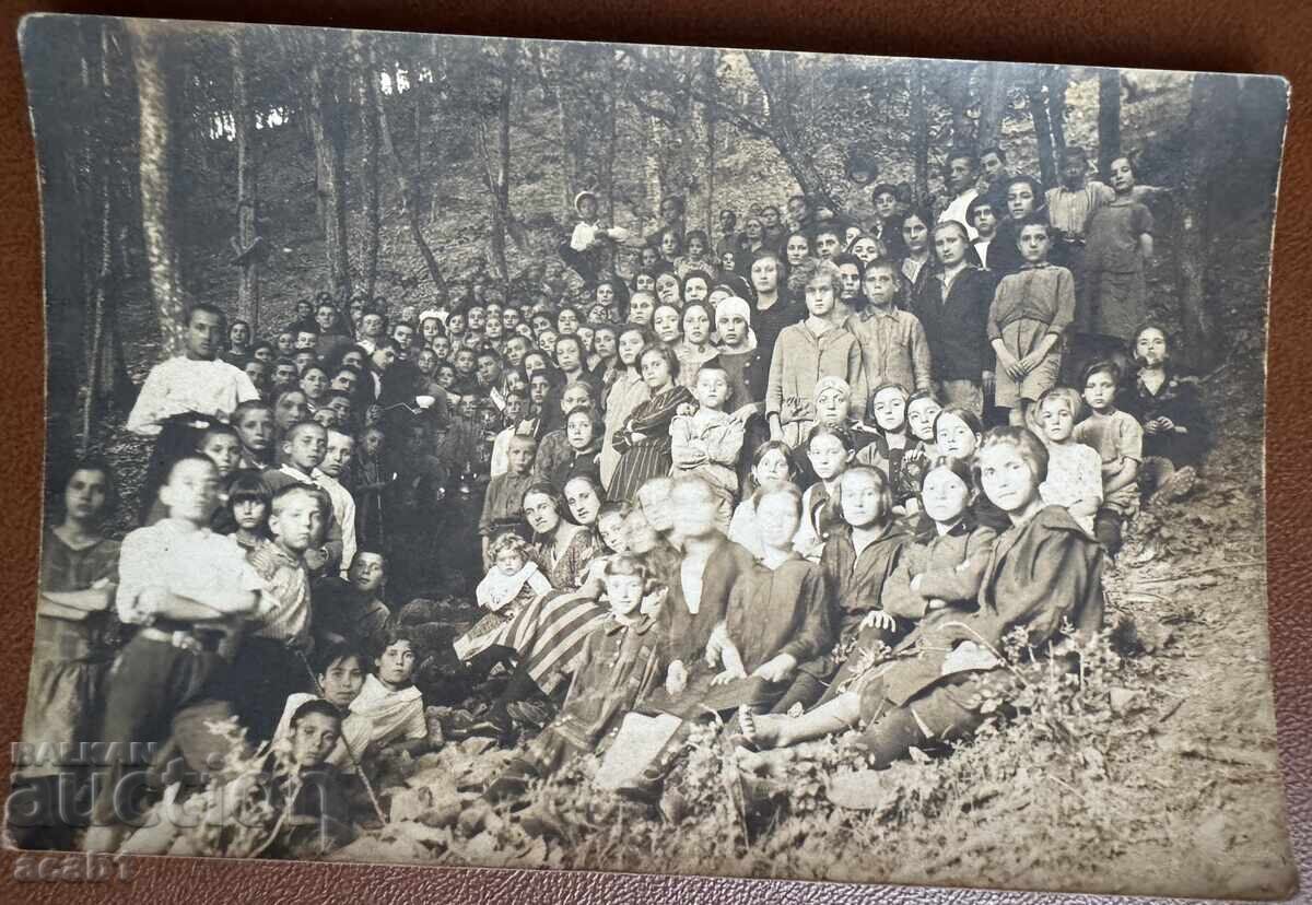 A group photo by the spring in the forest, lit with candles A group photo by the spring in the forest, lit with candles