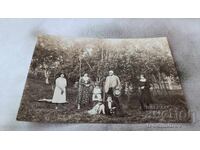 Photo Man women and girls in an apple orchard