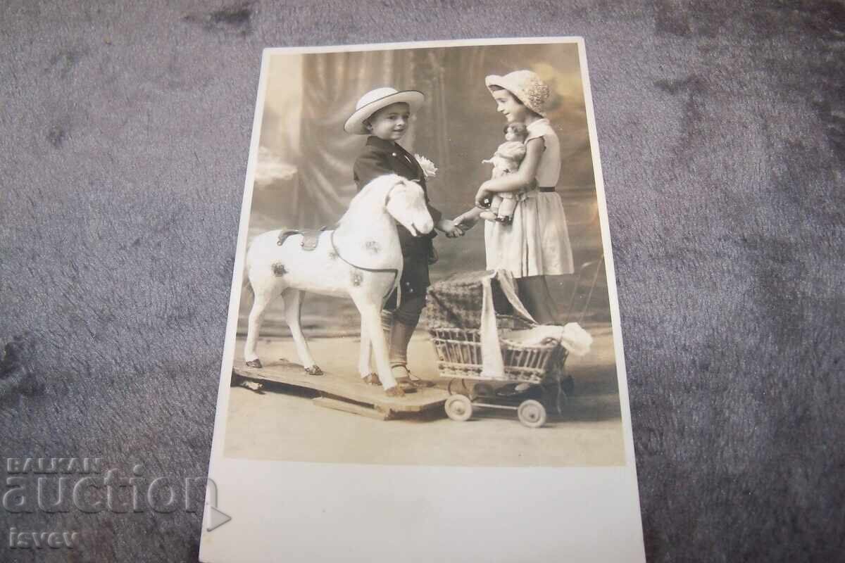 Old postcard photo of children with toys Old postcard photo of children with toys