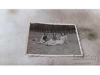 Photo Sofia Three young girls in a meadow by a swimming pool