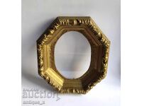 Old wooden picture frame with rich ornamentation