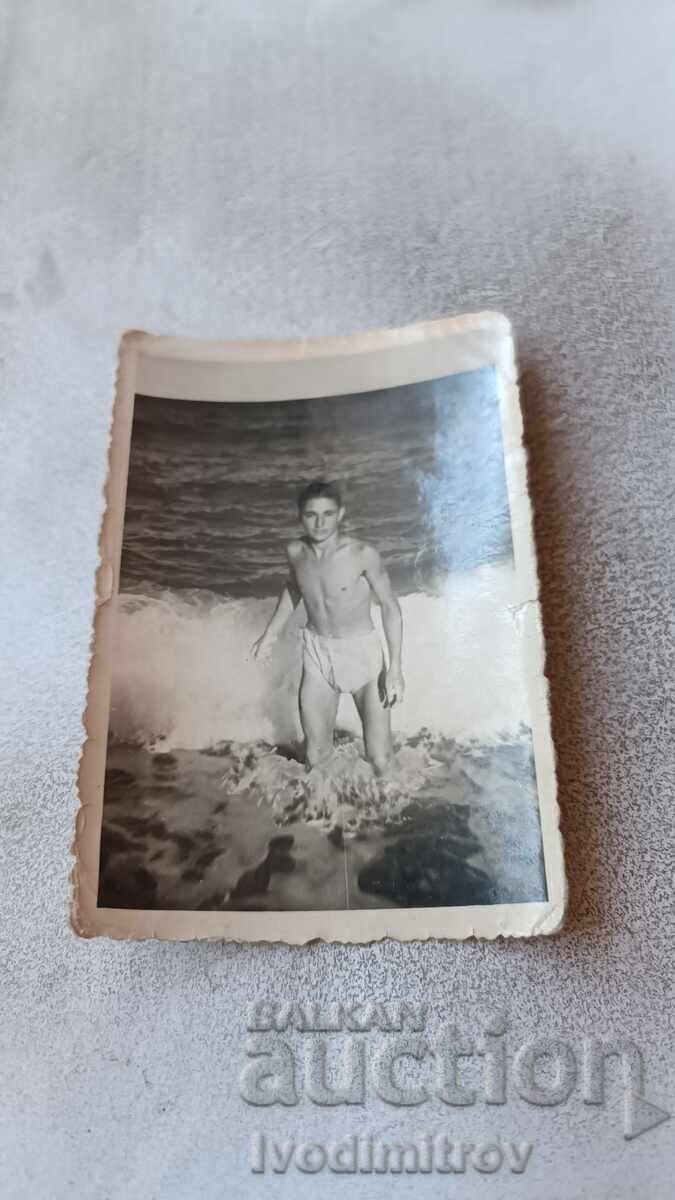 Fotografie Tânăr pe plajă Fotografie Tânăr pe plajă