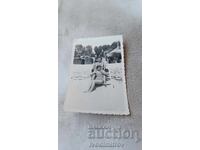 Photo Three young girls on a deck chair on the beach 1937