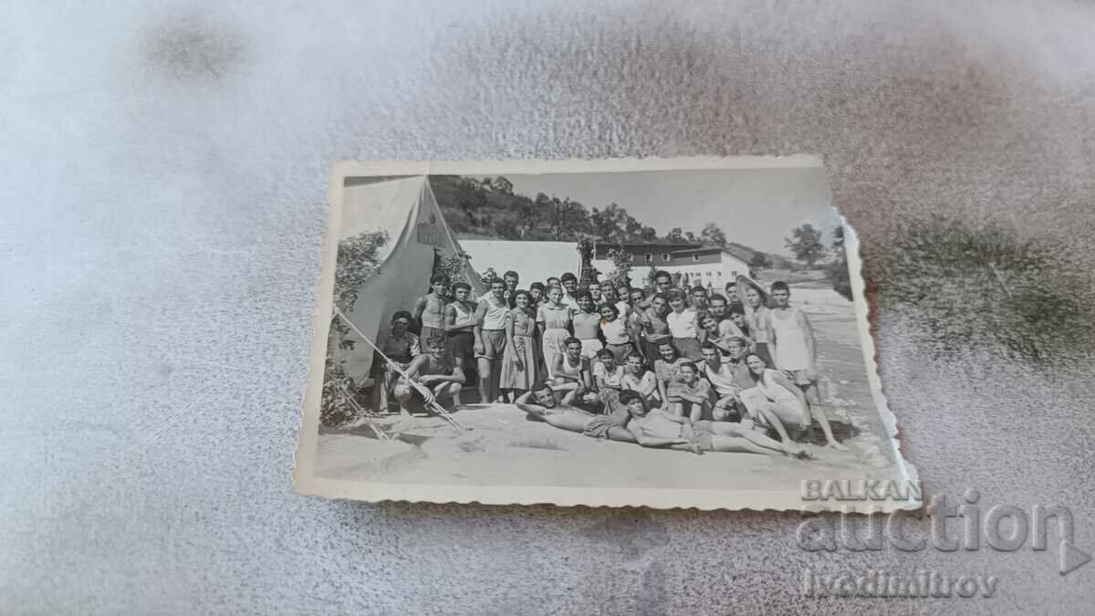 Photo: Young men and women in front of tents Photo: Young men and women in front of tents