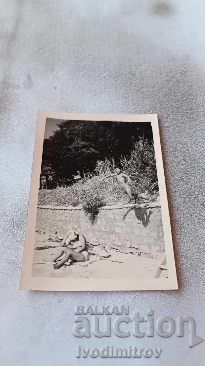 Photo Little boy jumping on the beach Photo Little boy jumping on the beach