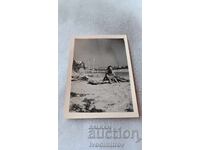 Photo: Man and little boy sitting on a mattress on the beach