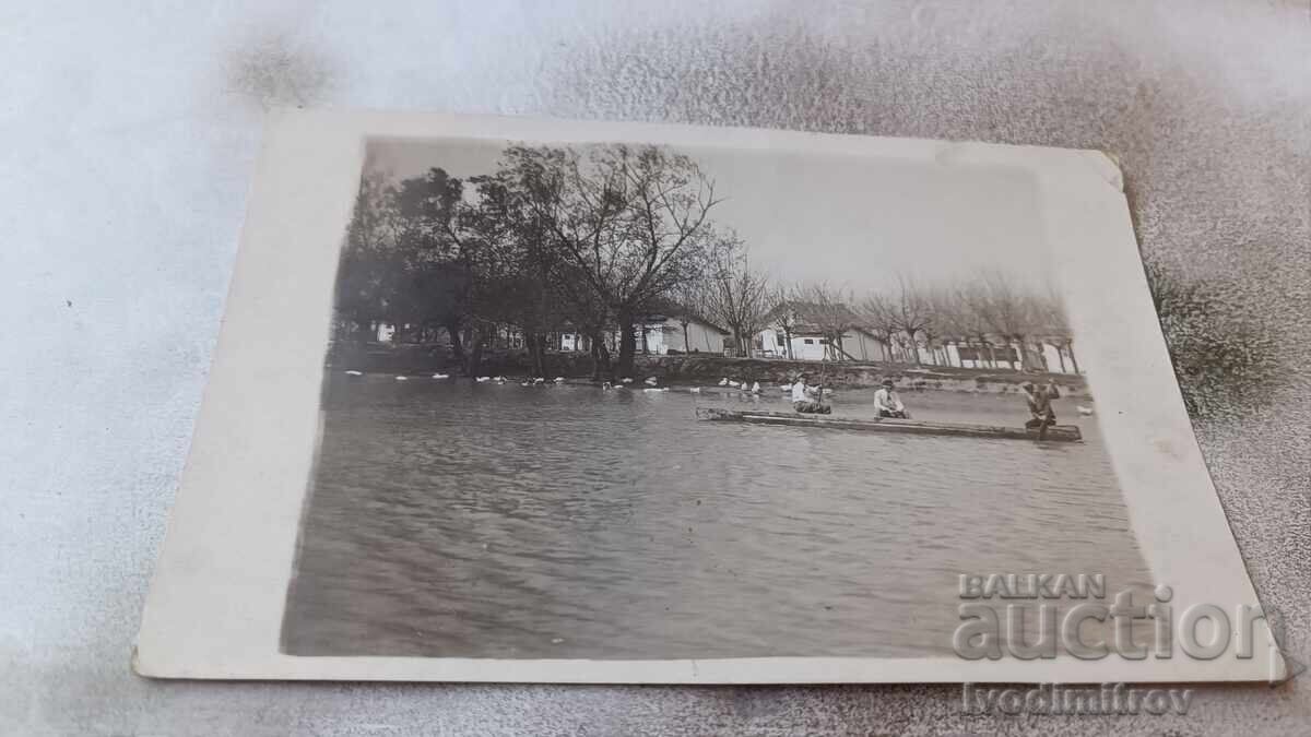 Photo Plovdiv Three men with a boat in the lake Photo Plovdiv Three men with a boat in the lake