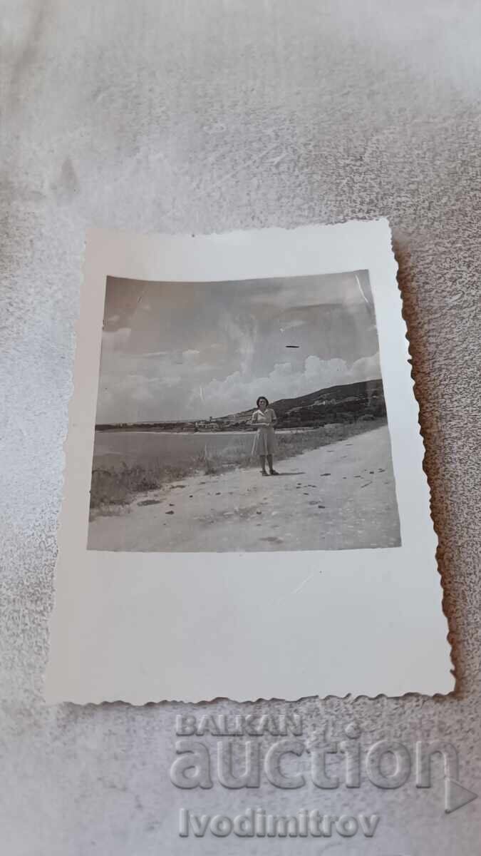 Photo Young girl by the sea Photo Young girl by the sea