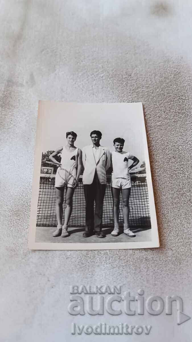 Photo Two young men coaching on a tennis court 1952 Photo Two young men coaching on a tennis court 1952