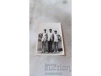 Photo Two young men coaching on a tennis court 1952