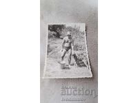 Photo: Man in swimsuit with wolf dog