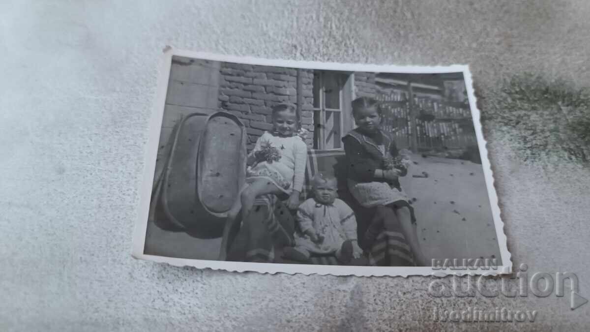 Photo Panagyurishte Two girls and a baby in the yard 1944 Photo Panagyurishte Two girls and a baby in the yard 1944