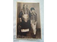 Old photo - girl and boy, children in folk costumes, 1940