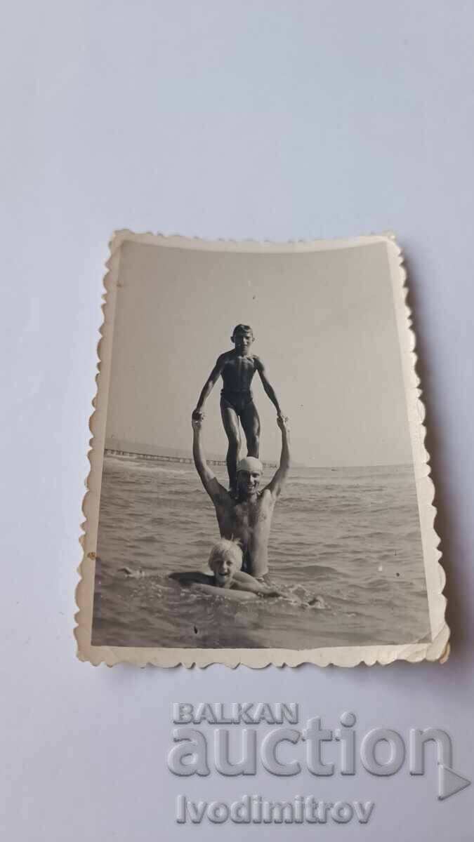 Photo Man and two boys in the sea