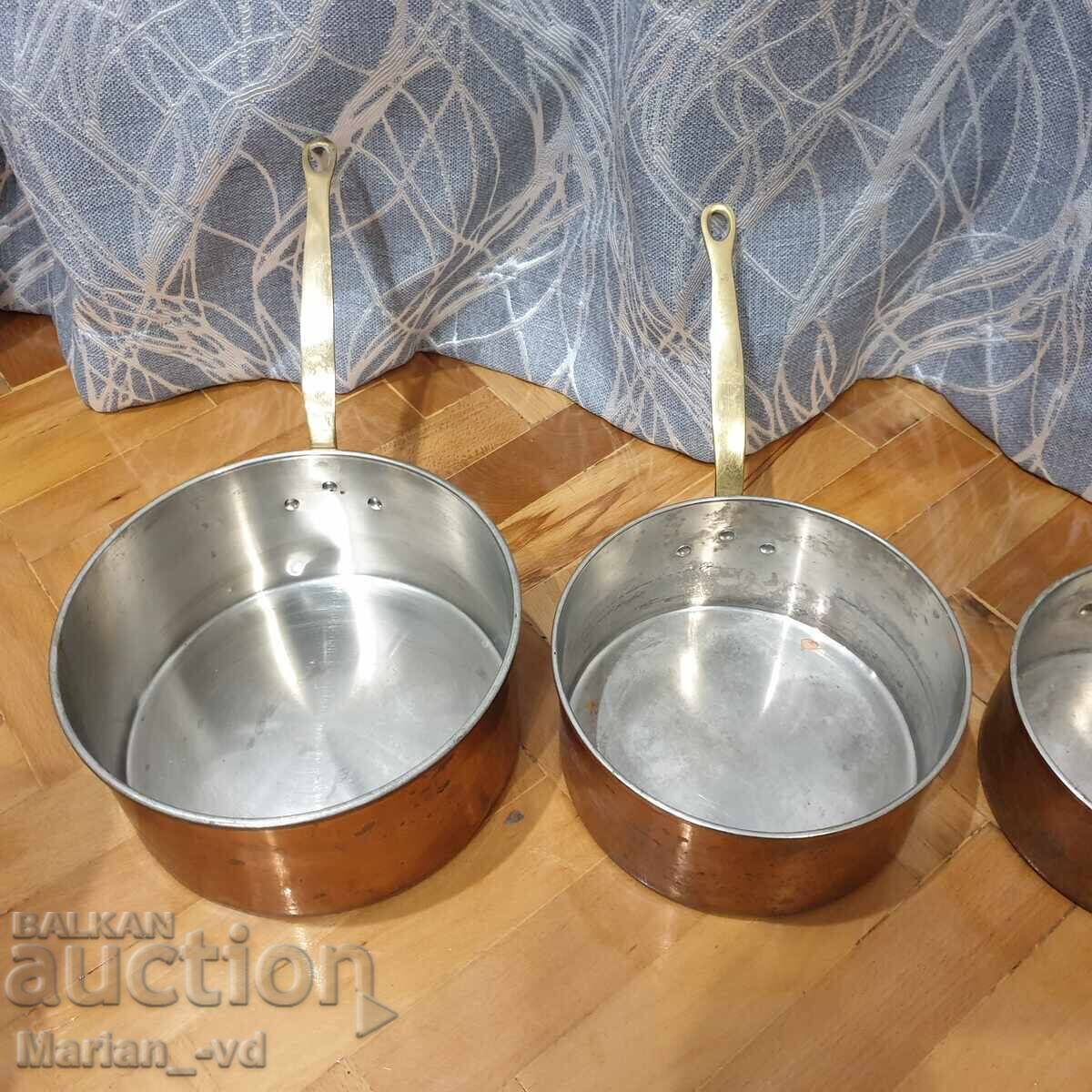 Auction Set of copper pans with bronze handles Auction Set of copper pans with bronze handles