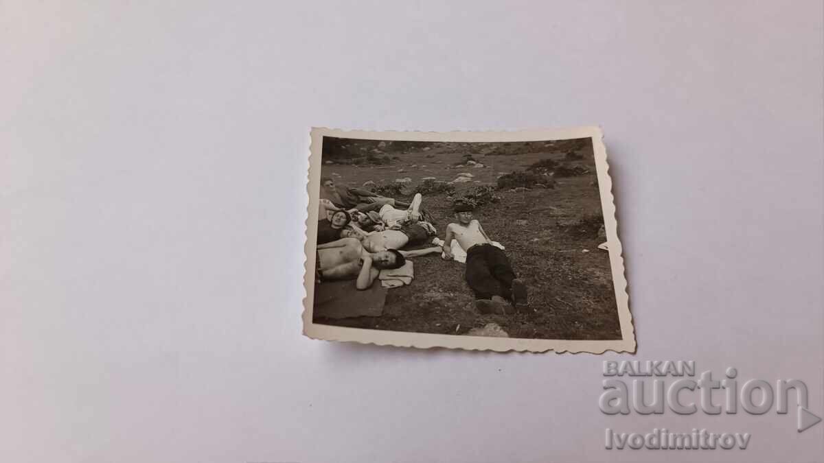 Photo of young people naked to the waist lying in a meadow Photo of young people naked to the waist lying in a meadow