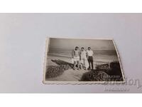 Photo Three young men on a path to the beach