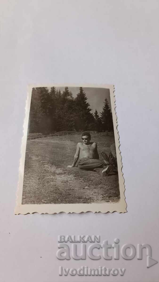Photo Rila Man naked to the waist sitting on the grass 1965 Photo Rila Man naked to the waist sitting on the grass 1965