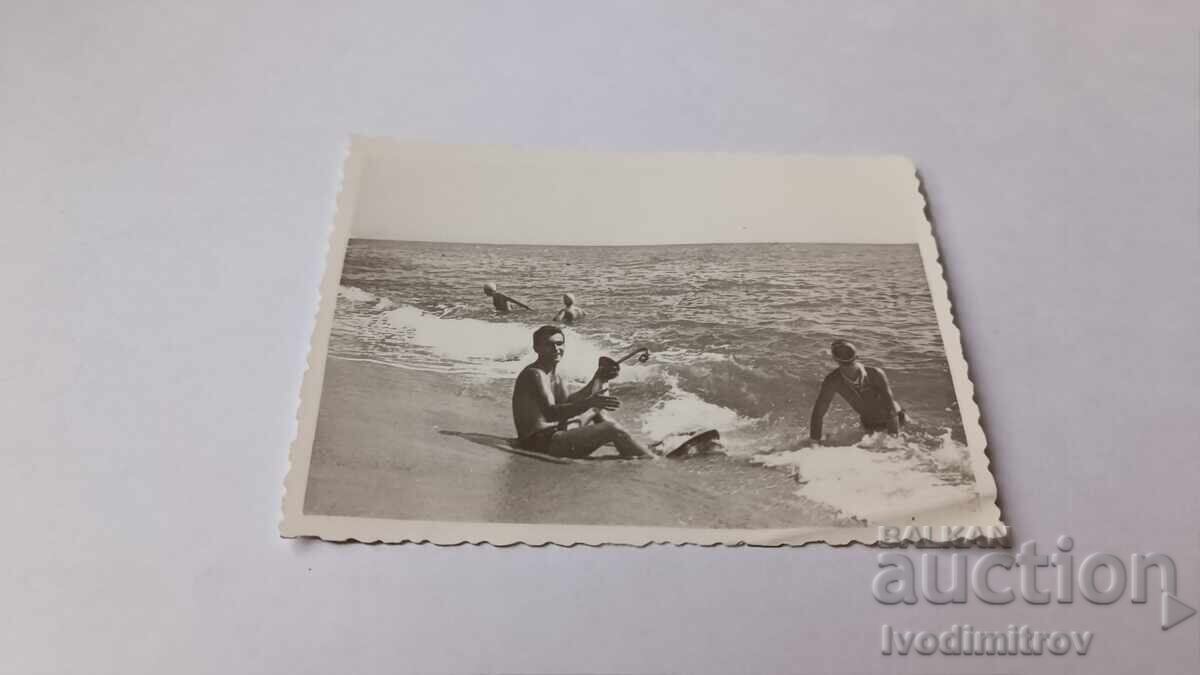Photo Two young men on the seashore Photo Two young men on the seashore