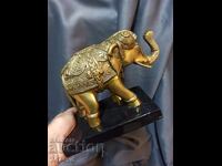 SOLID BRONZE PLASTIC OF AN ELEPHANT WITH A MARBLE PEDAL HANDLE.