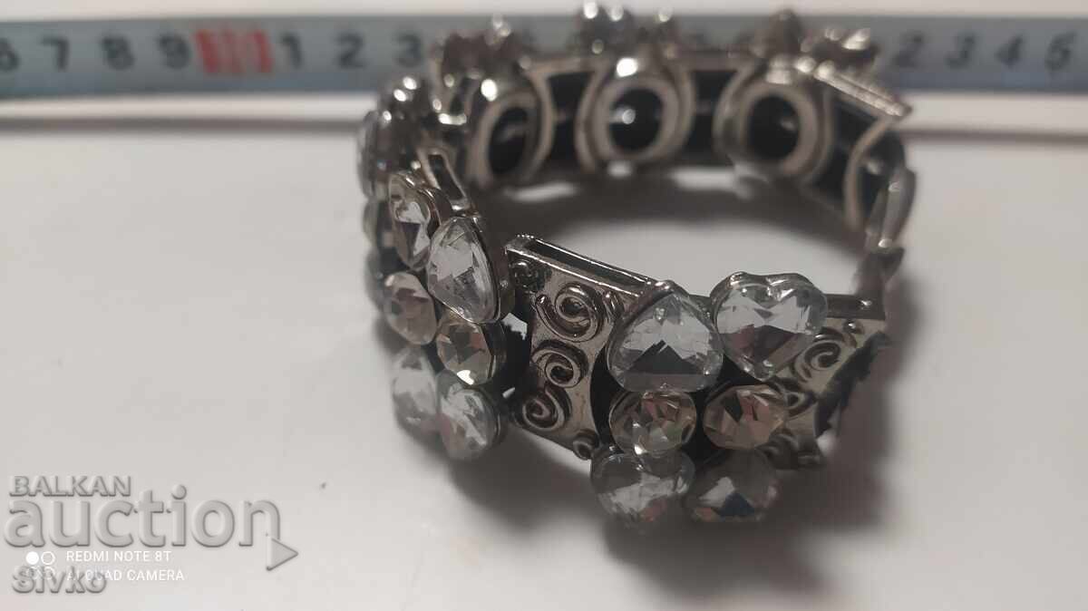 Auction Solid metal and white stone Hryvnia Auction Solid metal and white stone Hryvnia