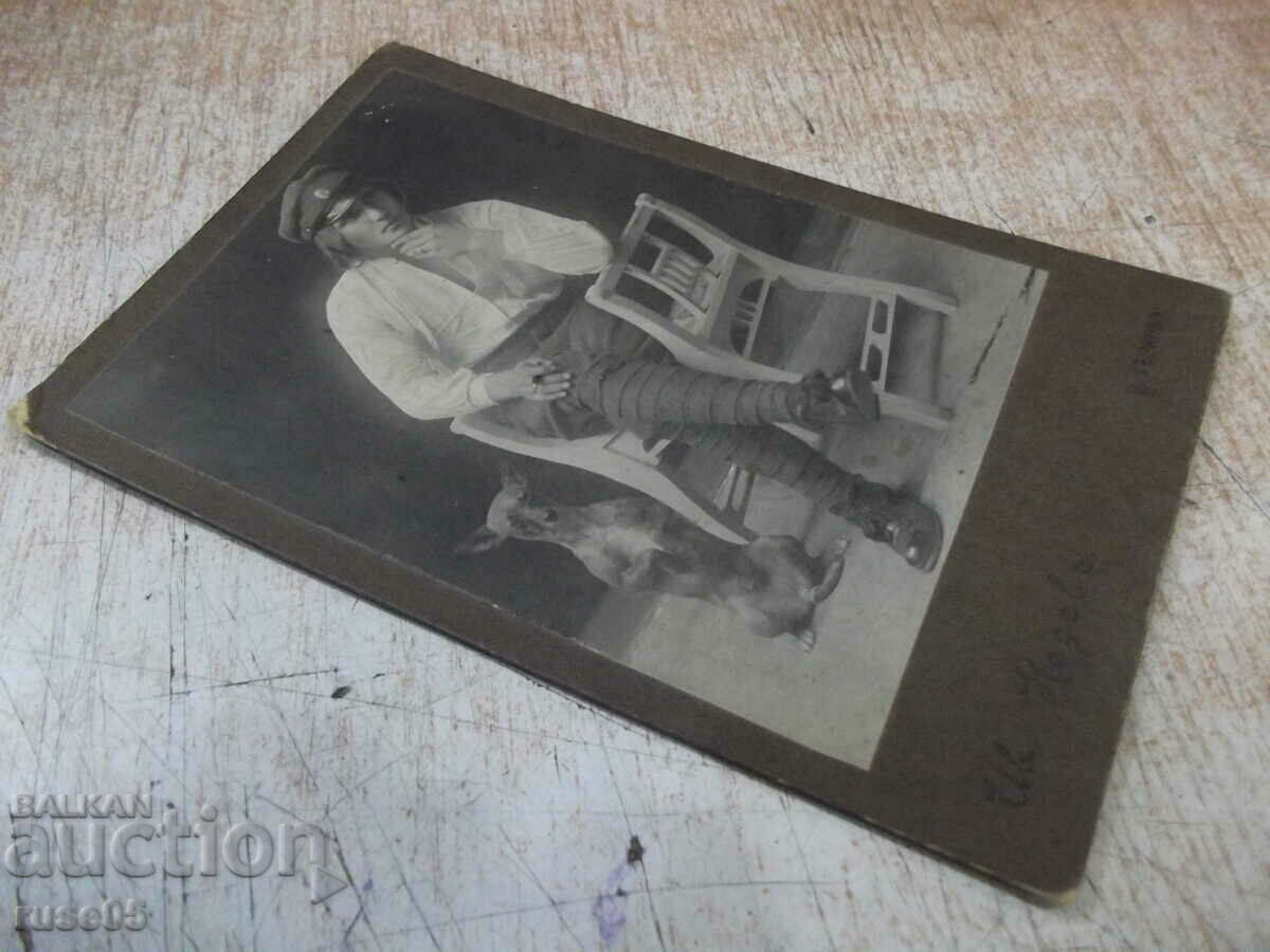 Auction Old photo of a pensive man with a dog on a cardboard chair Auction Old photo of a pensive man with a dog on a cardboard chair