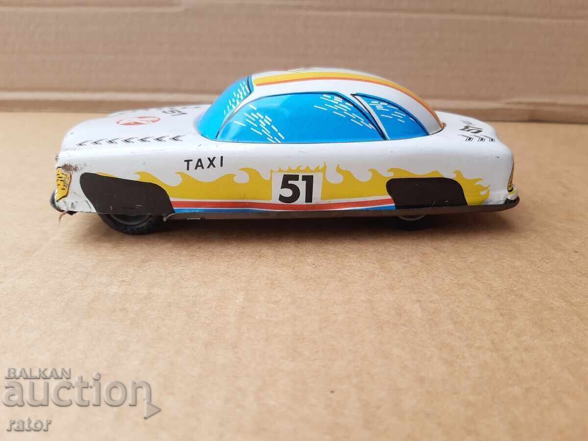 Old tin car, taxi, toy. Works