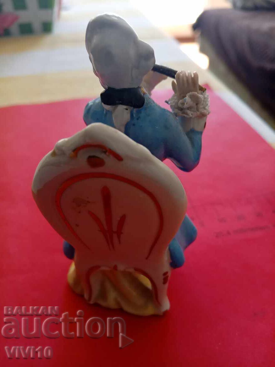 Auction  Antique porcelain figure, marked