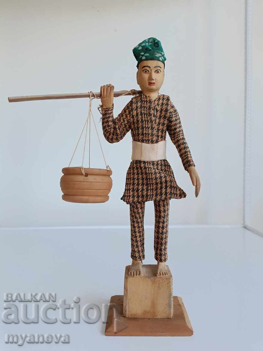 Vintage traditional wood carving of a farmer from Kathmandu, Nepal