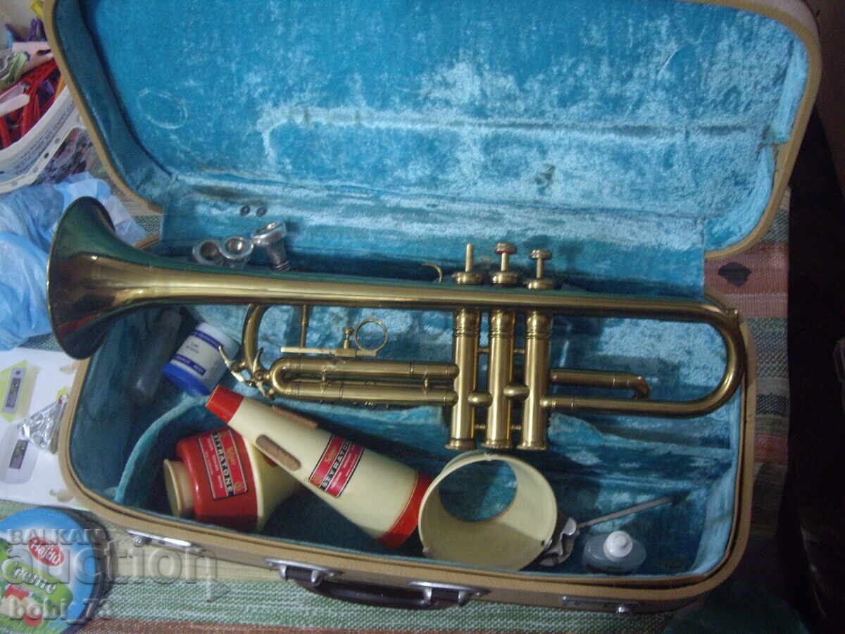 Old, working trumpet with various accessories