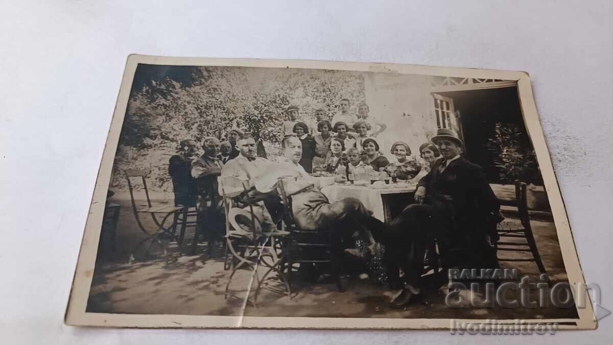 Photo Pancharevo: Men, women, and children at a table in the yard
