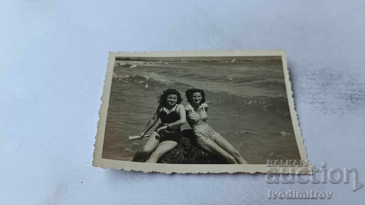 Photo of Two Young Girls on a Cliff by the Sea