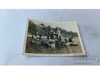 Photo of Young Men and Women with a Water Wheel in the Sea