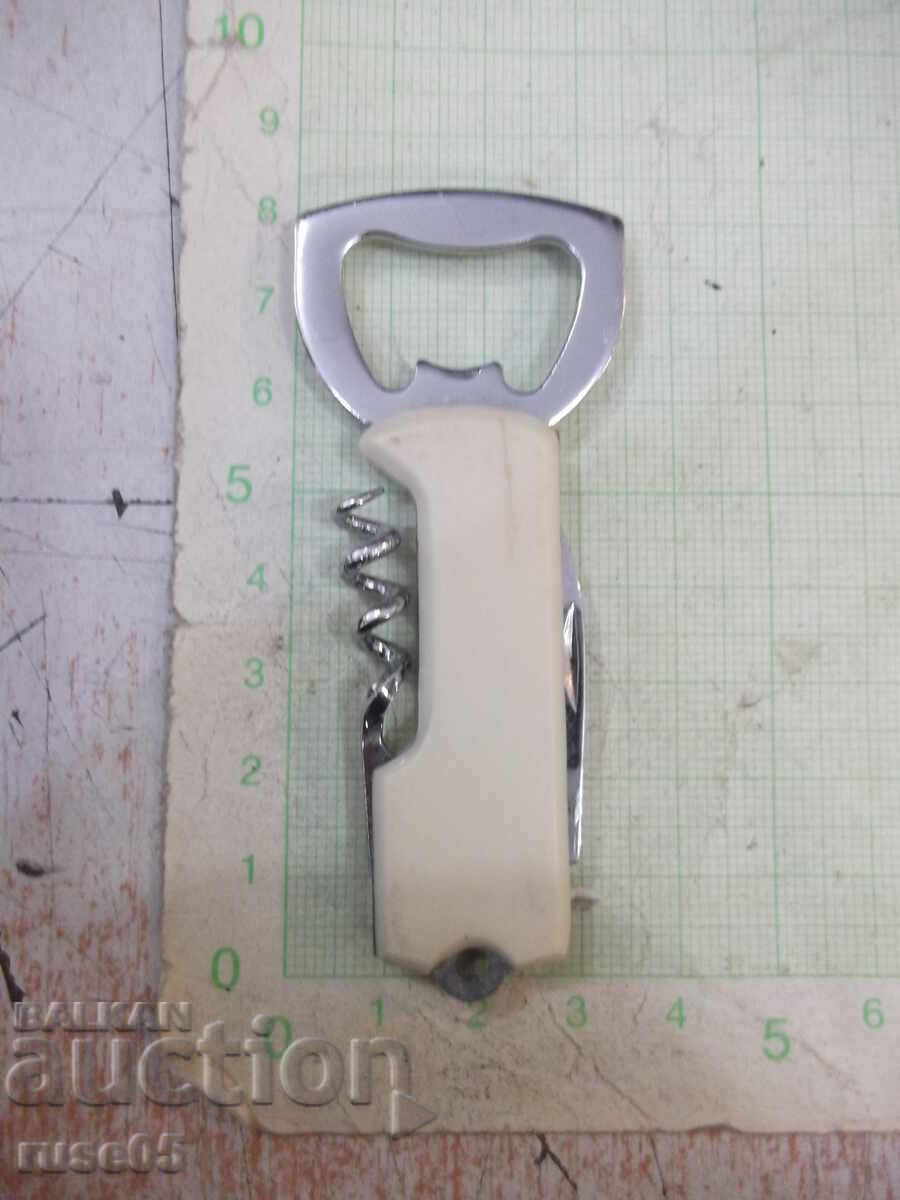 Bottle opener with corkscrew and knife