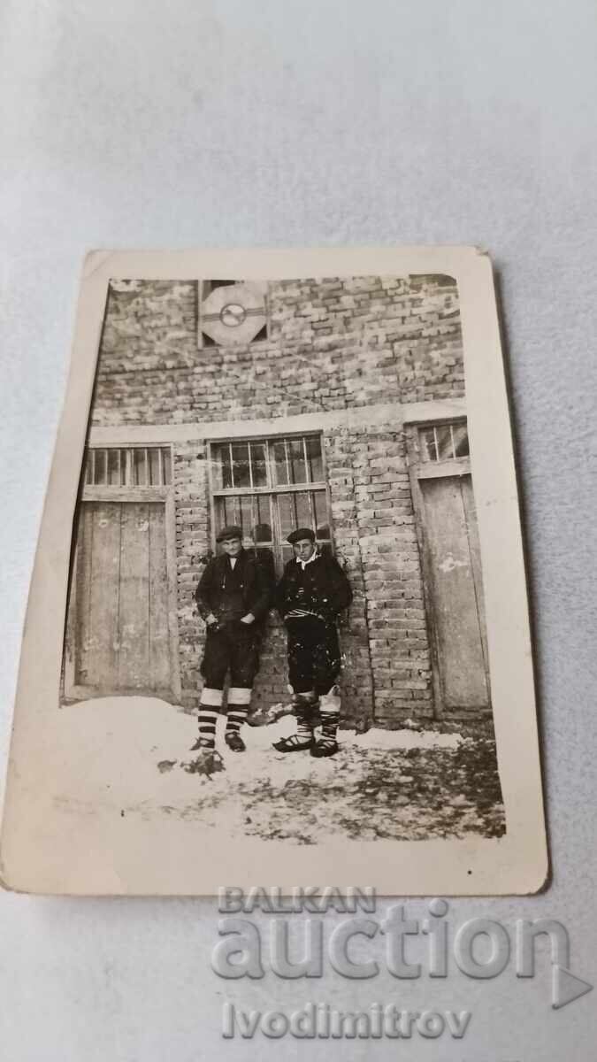 Photo of Two Young People in Front of an Unplastered Newly Built Building